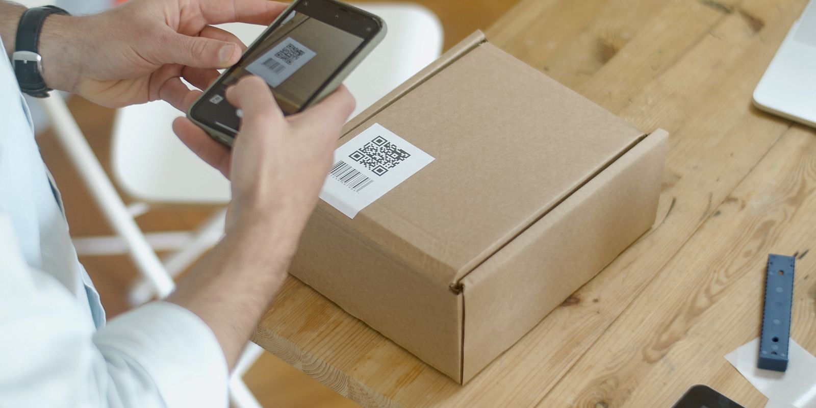 شخص يستخدم هاتفًا ذكيًا لمسح رمز QR على عبوة منتج، في مشهد يوضح فكرة ربط المنتجات ببيانات رقمية قابلة للوصول ضمن جواز المنتج الرقمي الأوروبي